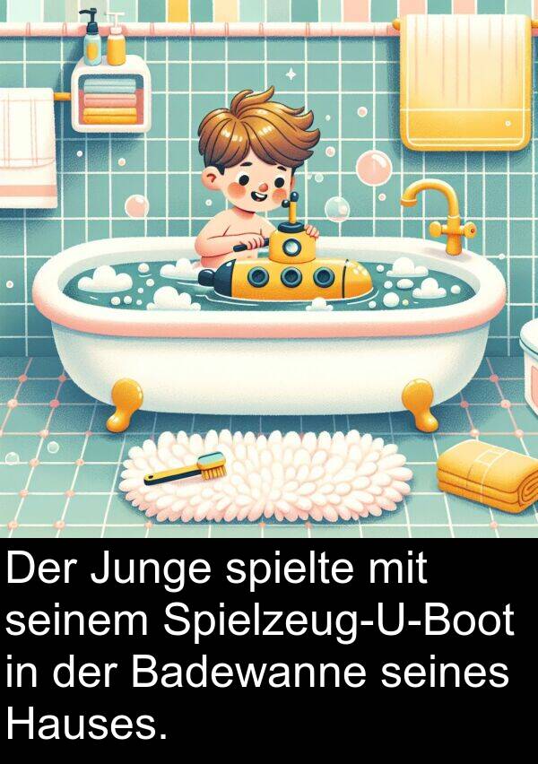 Junge: Der Junge spielte mit seinem Spielzeug-U-Boot in der Badewanne seines Hauses.