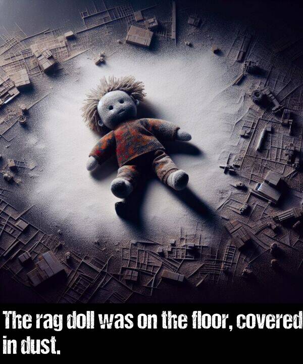 dust: The rag doll was on the floor, covered in dust.