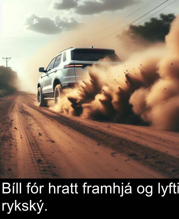 lyfti: Bíll fór hratt framhjá og lyfti rykský.