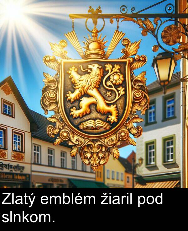 pod: Zlatý emblém žiaril pod slnkom.