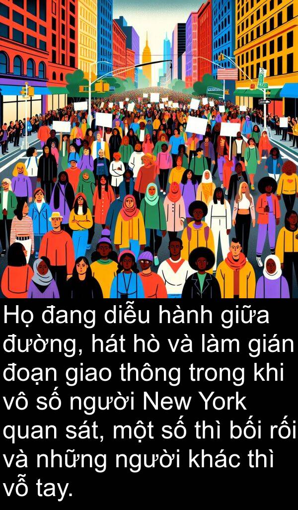 thì: Họ đang diễu hành giữa đường, hát hò và làm gián đoạn giao thông trong khi vô số người New York quan sát, một số thì bối rối và những người khác thì vỗ tay.